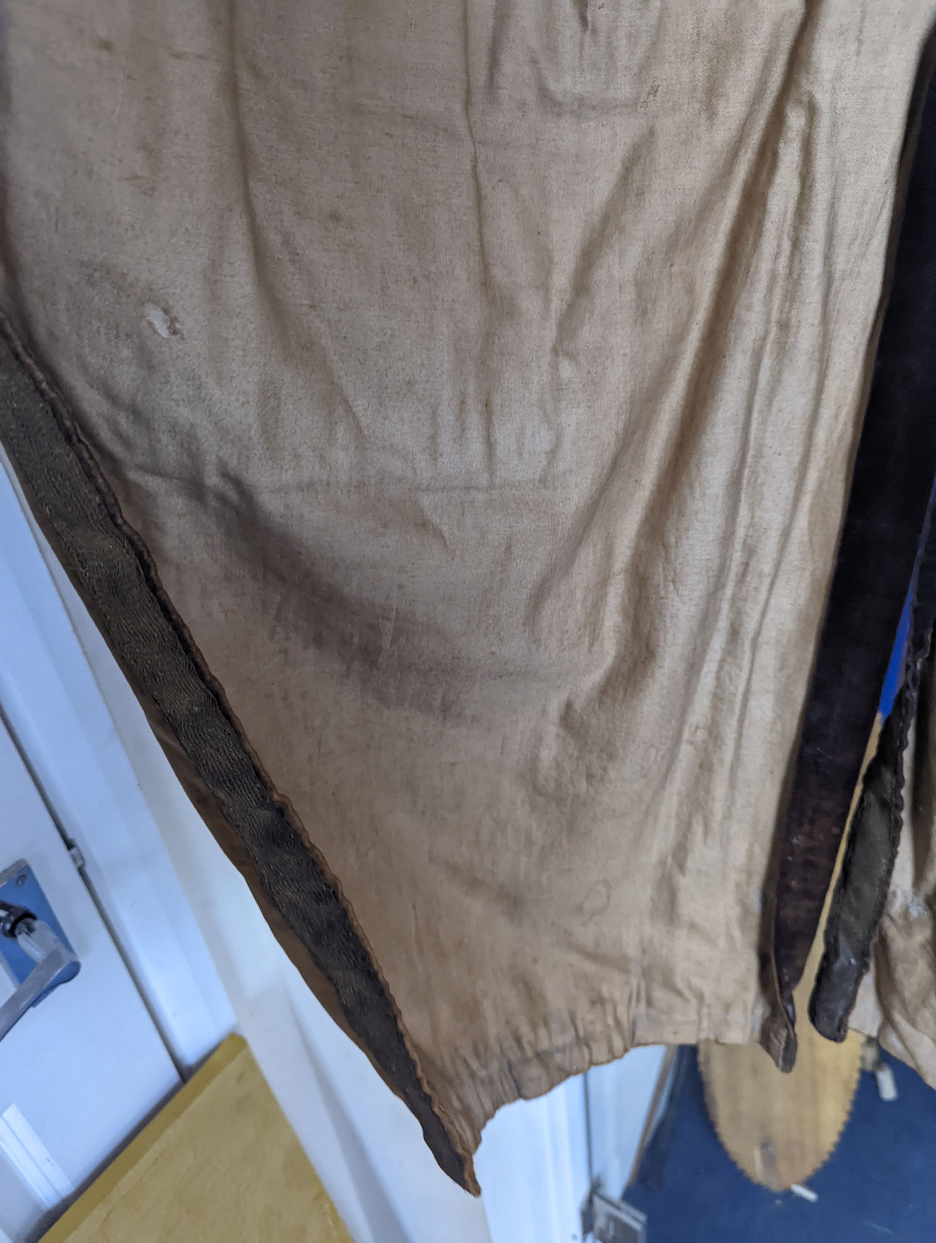 A Georgian gents cream damask waistcoat, a similar waistcoat with beading applied later and a velvet and gold braided tailcoat